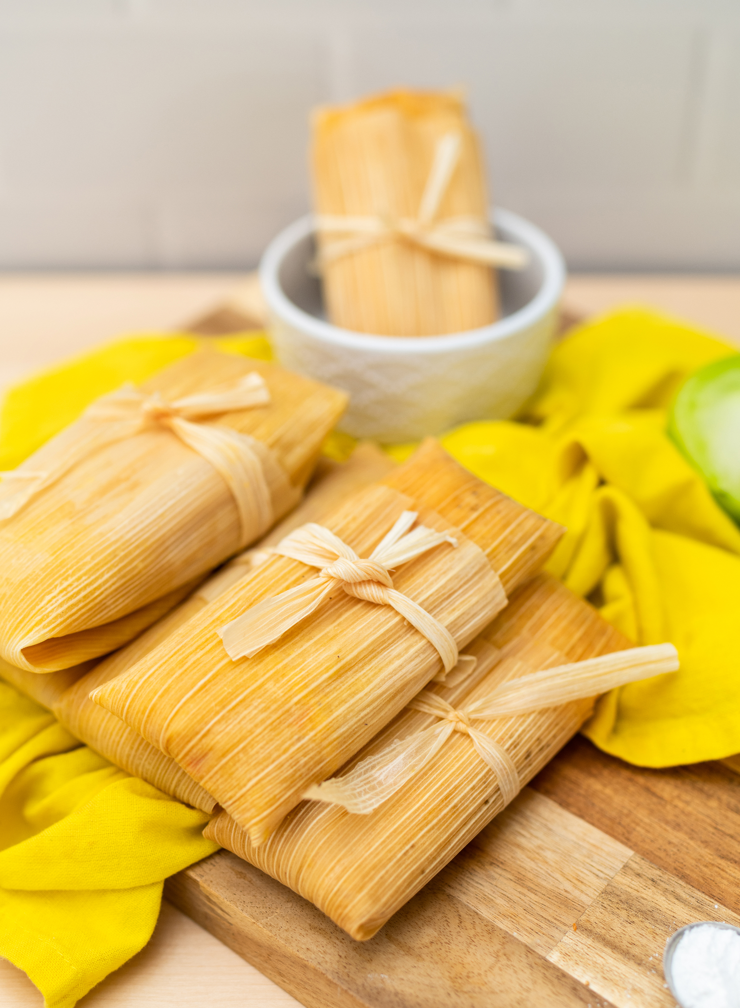 A picture containing tamale, food, dish, snack  Description automatically generated